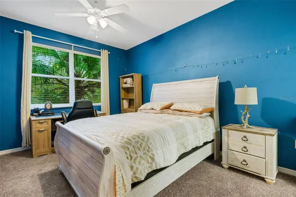a bedroom with a bed and large window