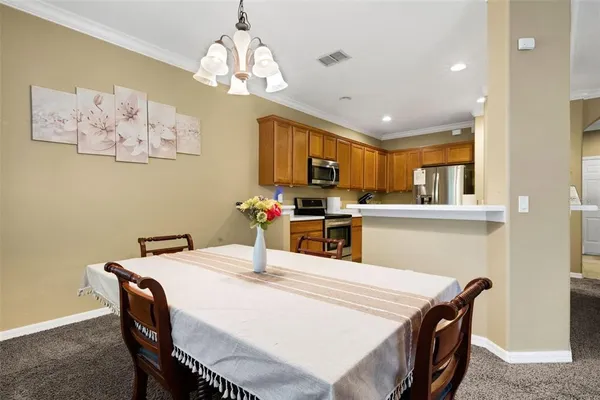 a kitchen with kitchen island a dining table and chairs
