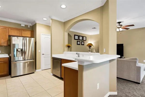 a kitchen with stainless steel appliances kitchen island a sink a refrigerator and a stove