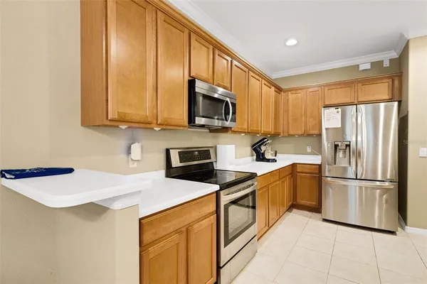 a kitchen with stainless steel appliances granite countertop a refrigerator stove top oven and sink