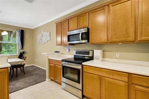 a kitchen with stainless steel appliances granite countertop a stove a sink and a microwave