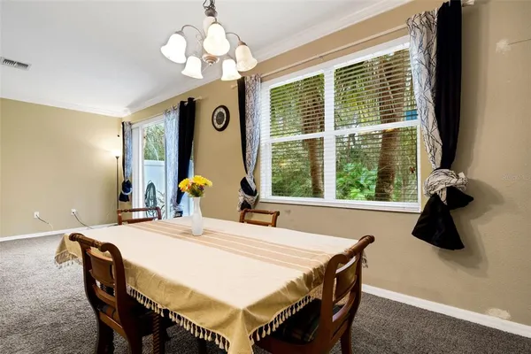 a dining room with a large window table and chairs