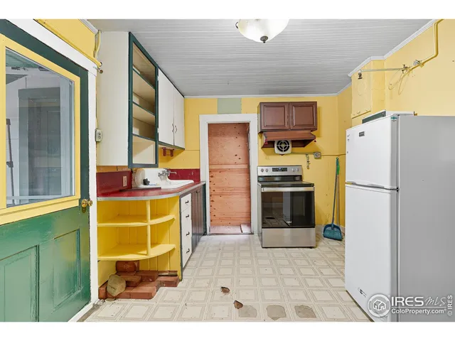 a kitchen with stainless steel appliances a refrigerator and a stove top oven