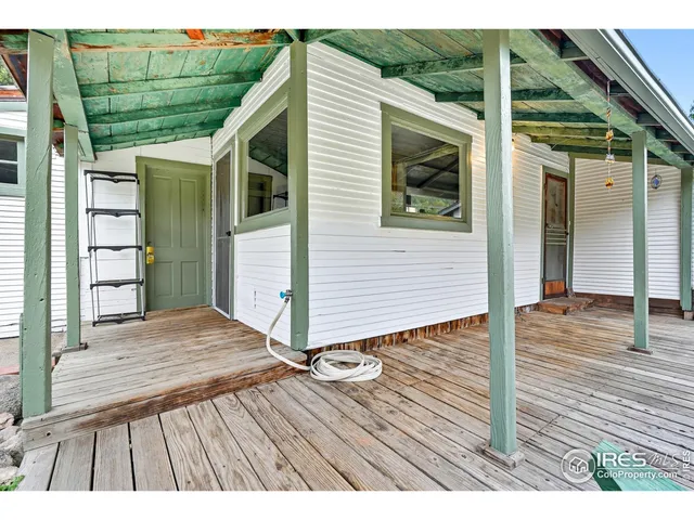 a view of backyard with a deck and wooden floor