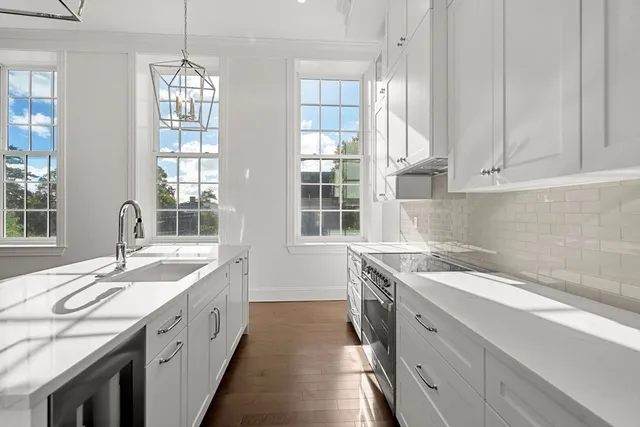 a kitchen with a sink stove and cabinets
