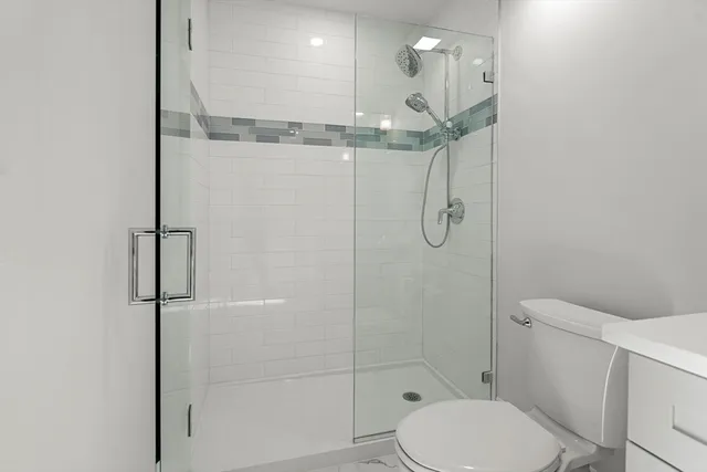 a bathroom with a toilet and a shower