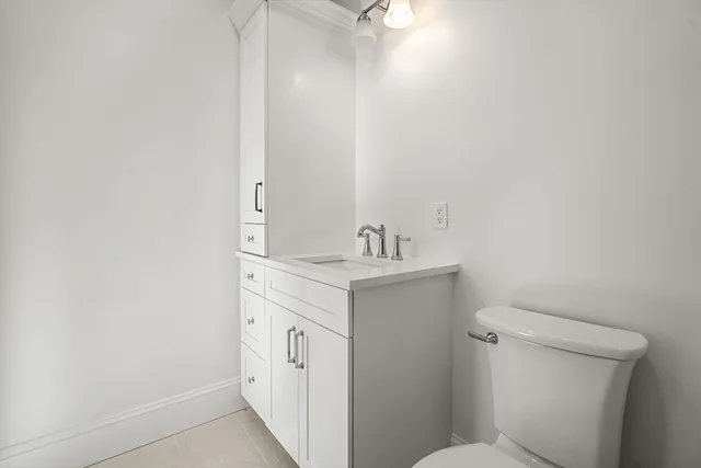 a bathroom with a sink toilet and vanity