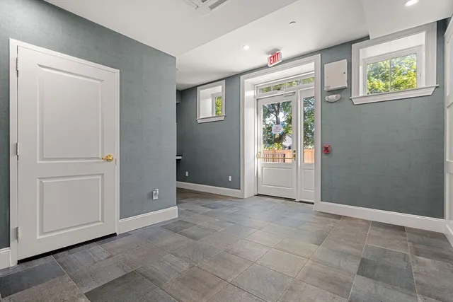 an empty room with windows and closet