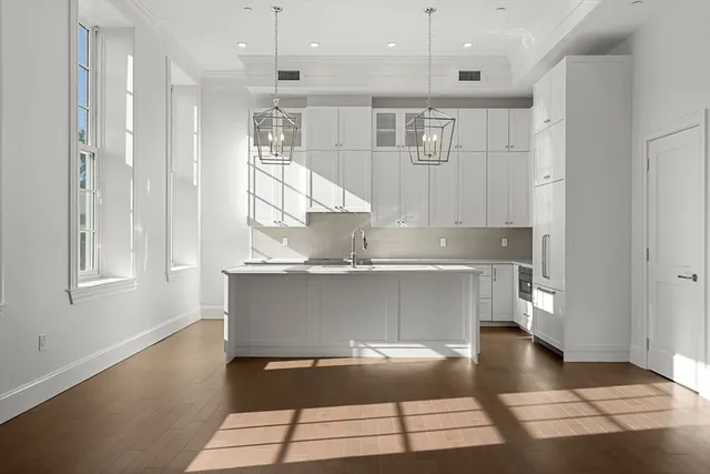 a kitchen with kitchen island a counter top space appliances and a window