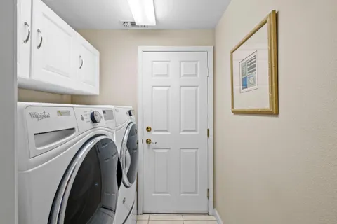 a view of washer and dryer with kitchen in the background