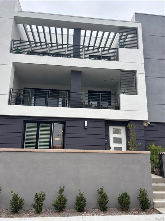 16175 Dawn Way, Unit 108 Tustin, CA 92782 - Photo 1 of 12 a building view with a outdoor space