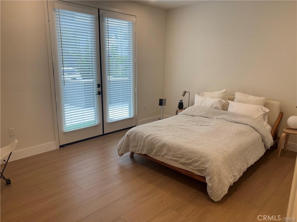 16175 Dawn Way, Unit 108 Tustin, CA 92782 - Photo 5 of 12 a large bed sitting in a bedroom next to a window