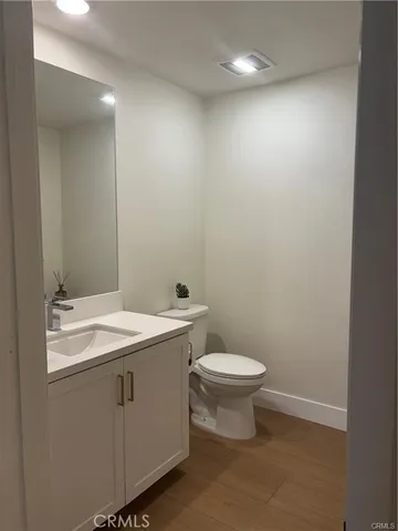 a bathroom with a sink a toilet and mirror