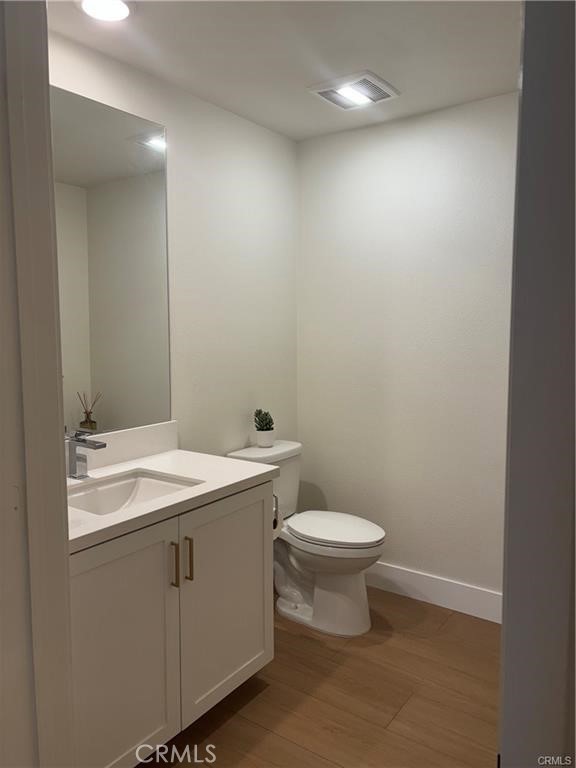 16175 Dawn Way, Unit 108 Tustin, CA 92782 - Photo 8 of 12 a bathroom with a sink a toilet and mirror