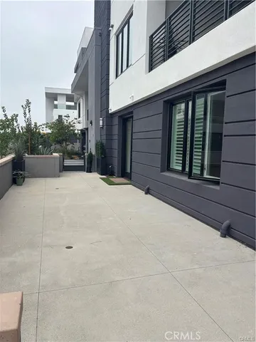 a view of a house with potted plants