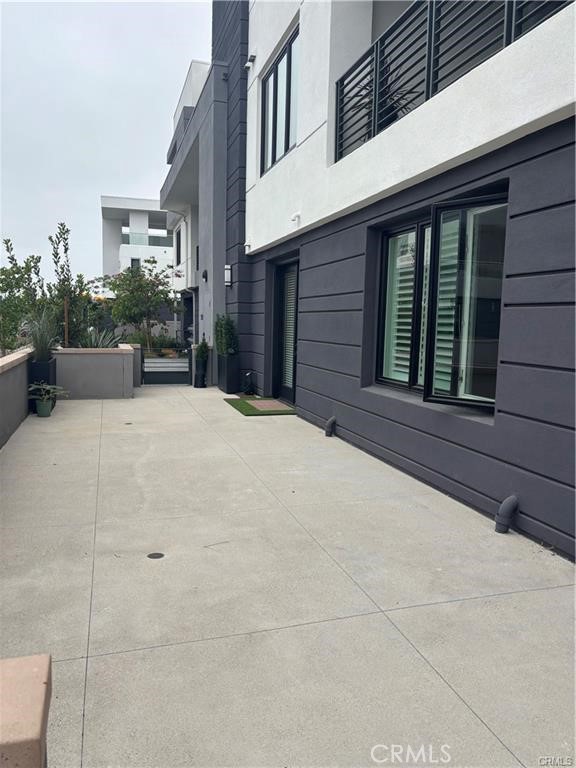 16175 Dawn Way, Unit 108 Tustin, CA 92782 - Photo 9 of 12 a view of a house with potted plants