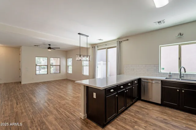 a kitchen with a sink window and cabinets