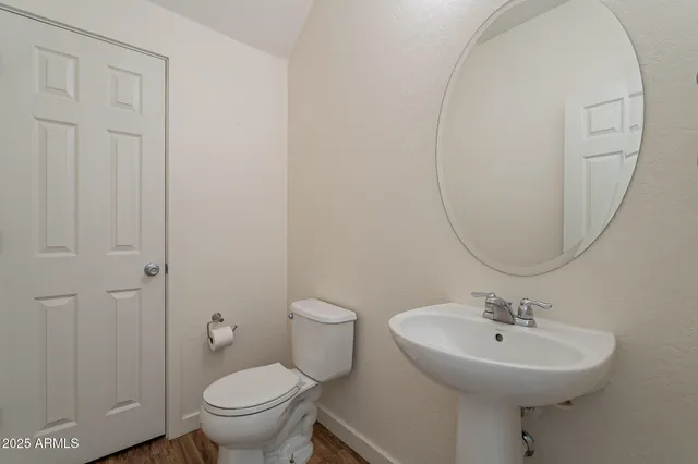 a bathroom with a sink a toilet and a mirror