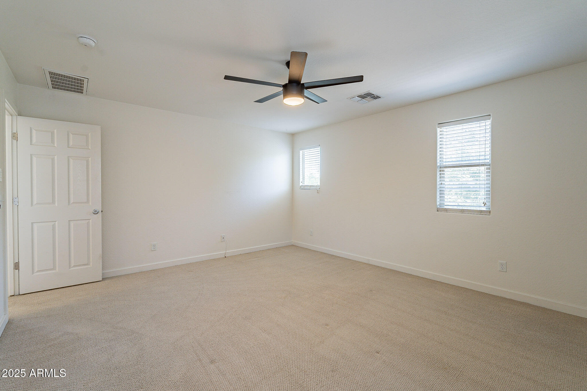 1061 South Hawk Lane Gilbert, AZ 85296 - Photo 15 of 23 an empty room with a window and a fan