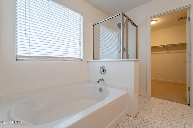 a white bath tub sitting next to a window
