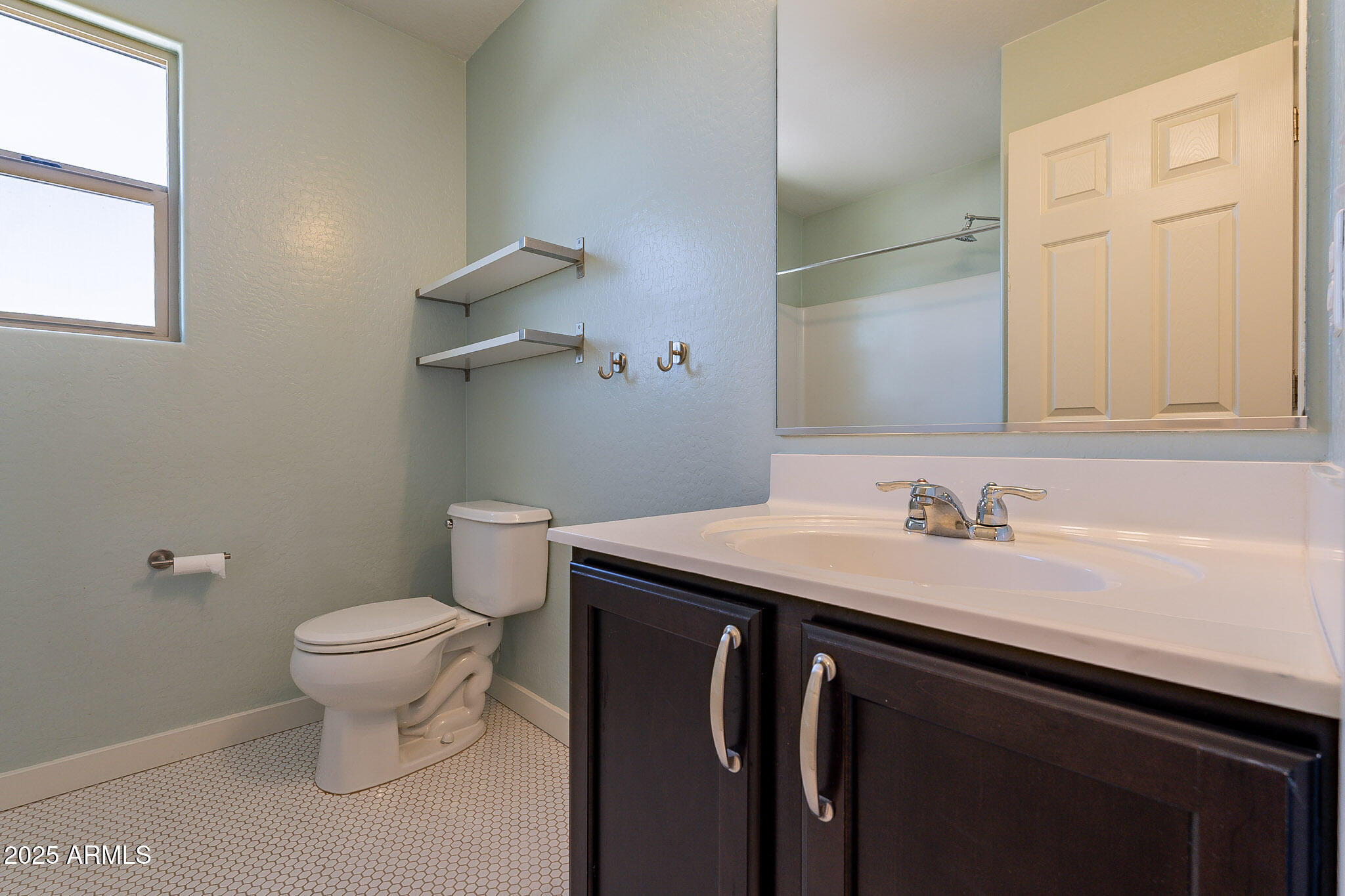 1061 South Hawk Lane Gilbert, AZ 85296 - Photo 19 of 23 a bathroom with a granite countertop sink a toilet and a mirror