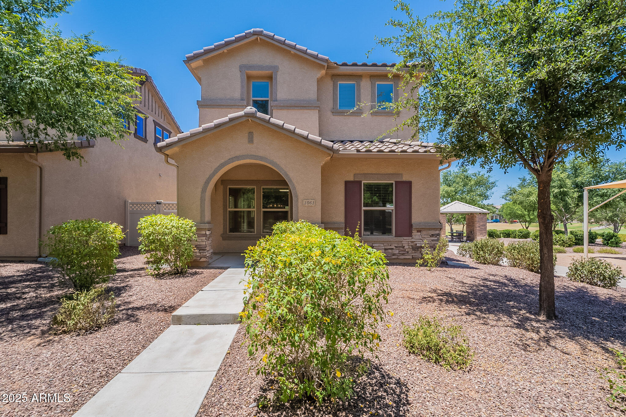 1061 South Hawk Lane Gilbert, AZ 85296 - Photo 2 of 23 a front view of a house with garden