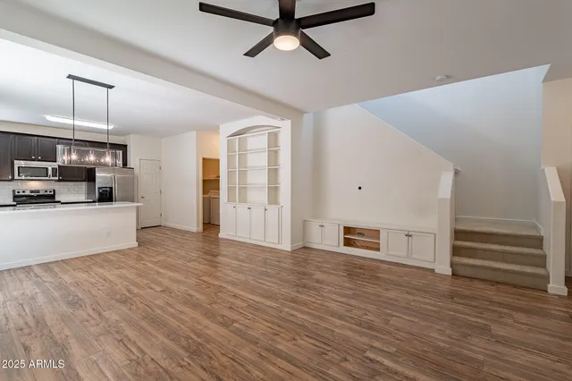 a view of a kitchen with wooden floor and electronic appliances
