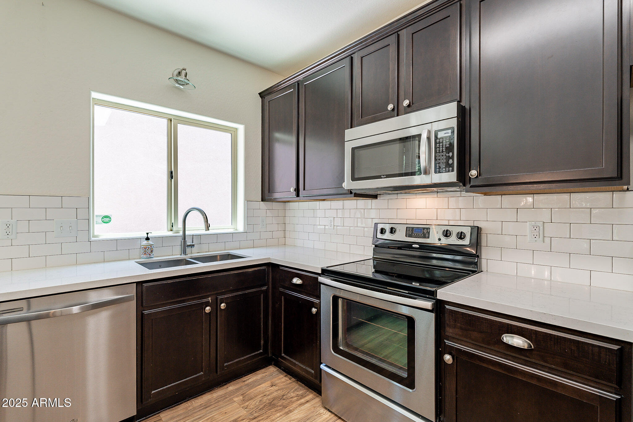 1061 South Hawk Lane Gilbert, AZ 85296 - Photo 8 of 23 a kitchen with a sink stove and microwave