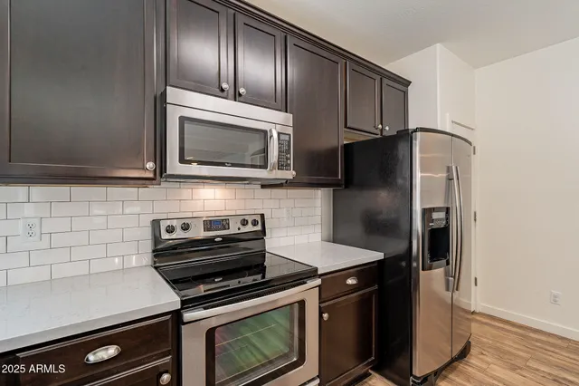 a kitchen with granite countertop cabinets and steel stainless steel appliances