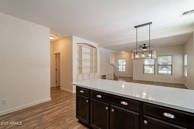 a spacious bathroom with a granite countertop sink a mirror and a shower