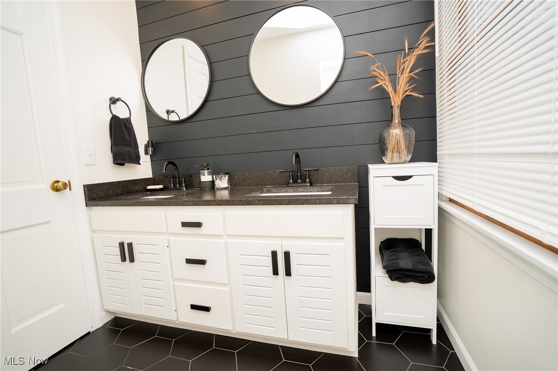 8651 King Graves Road Northeast Warren, OH 44484 - Photo 11 of 24 Bathroom with tile patterned floors, vanity, and wooden walls
