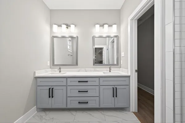 a bathroom with a double vanity sink and mirror