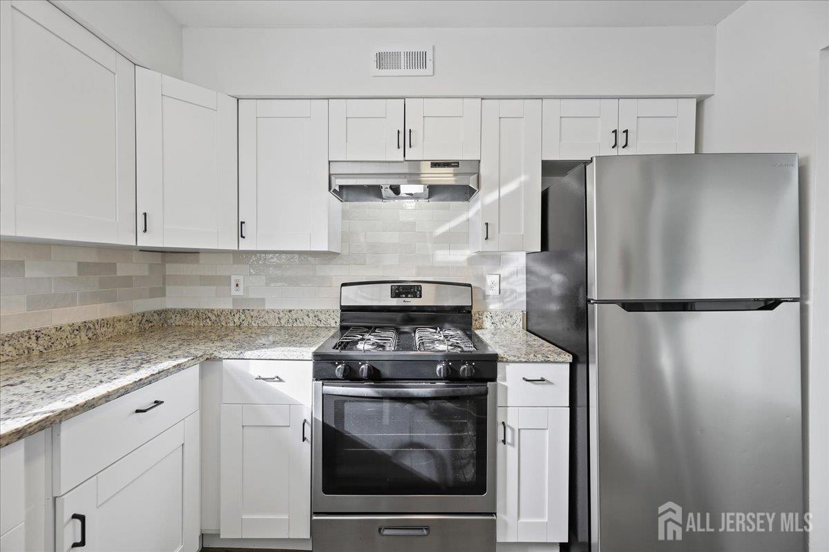 13 Lamont Court Sicklerville, NJ 08081 - Photo 11 of 25 a kitchen with cabinets and stainless steel appliances