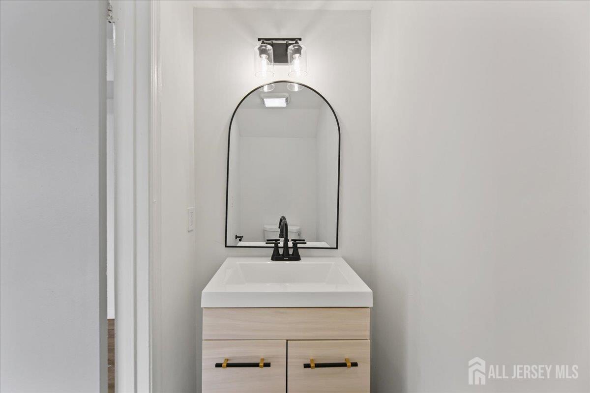 13 Lamont Court Sicklerville, NJ 08081 - Photo 14 of 25 a bathroom with a sink and a mirror