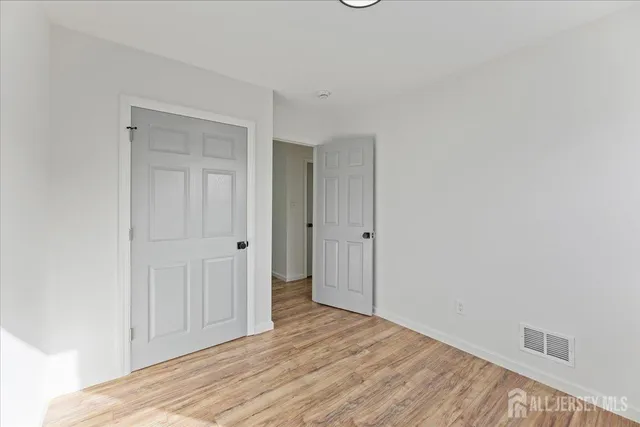 a view of hallway with wooden floor