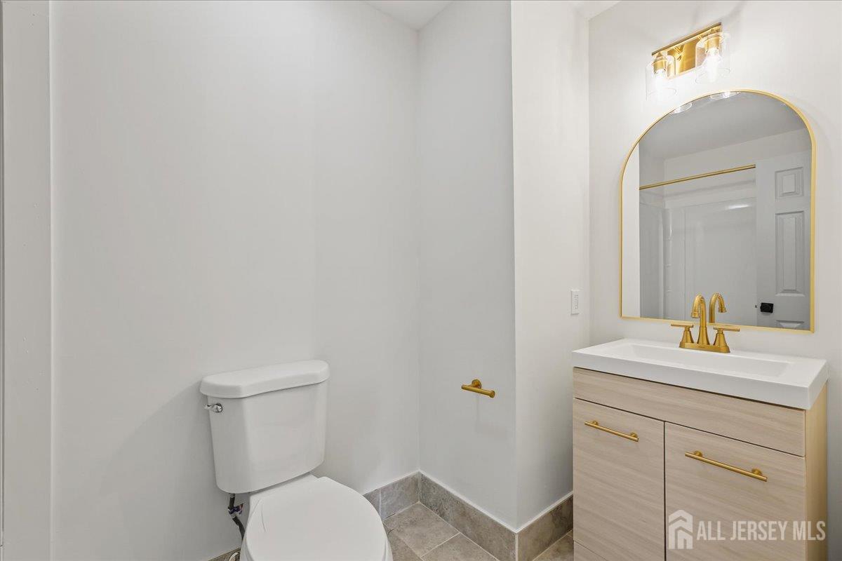 13 Lamont Court Sicklerville, NJ 08081 - Photo 18 of 25 a bathroom with a toilet sink vanity and mirror
