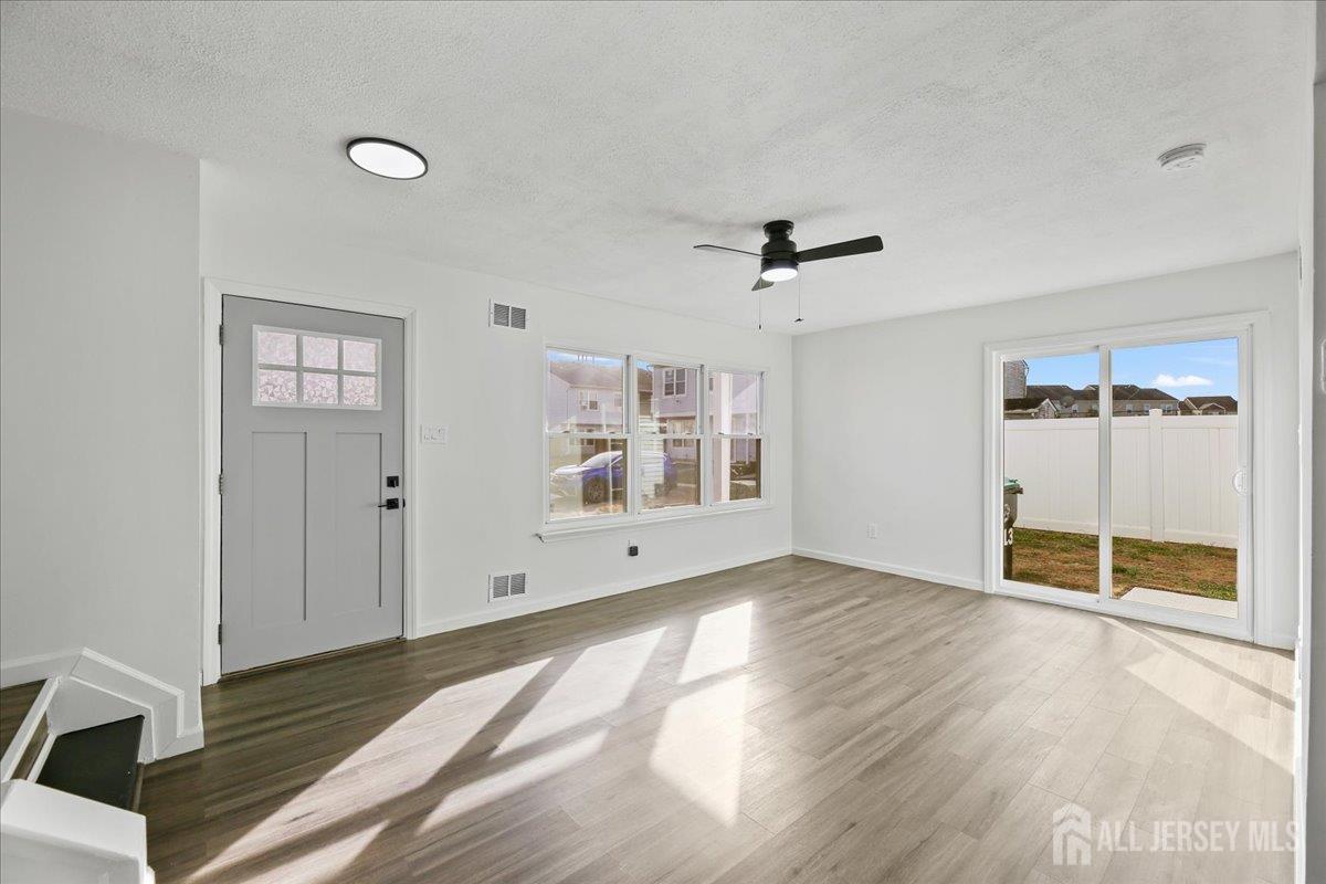 13 Lamont Court Sicklerville, NJ 08081 - Photo 7 of 25 a view of an empty room with wooden floor and a window