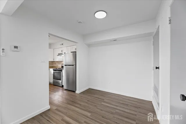 a view of a kitchen with a sink and a refrigerator