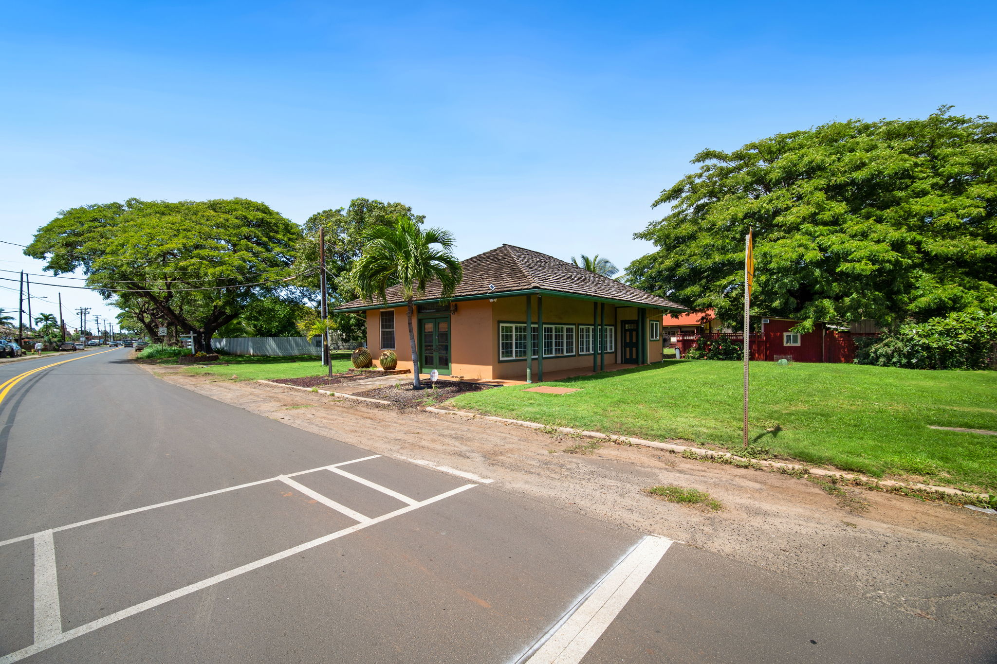 8297 Kekaha Road Kekaha, HI 96752 - Photo 1 of 27 a view of a house with a yard and a street