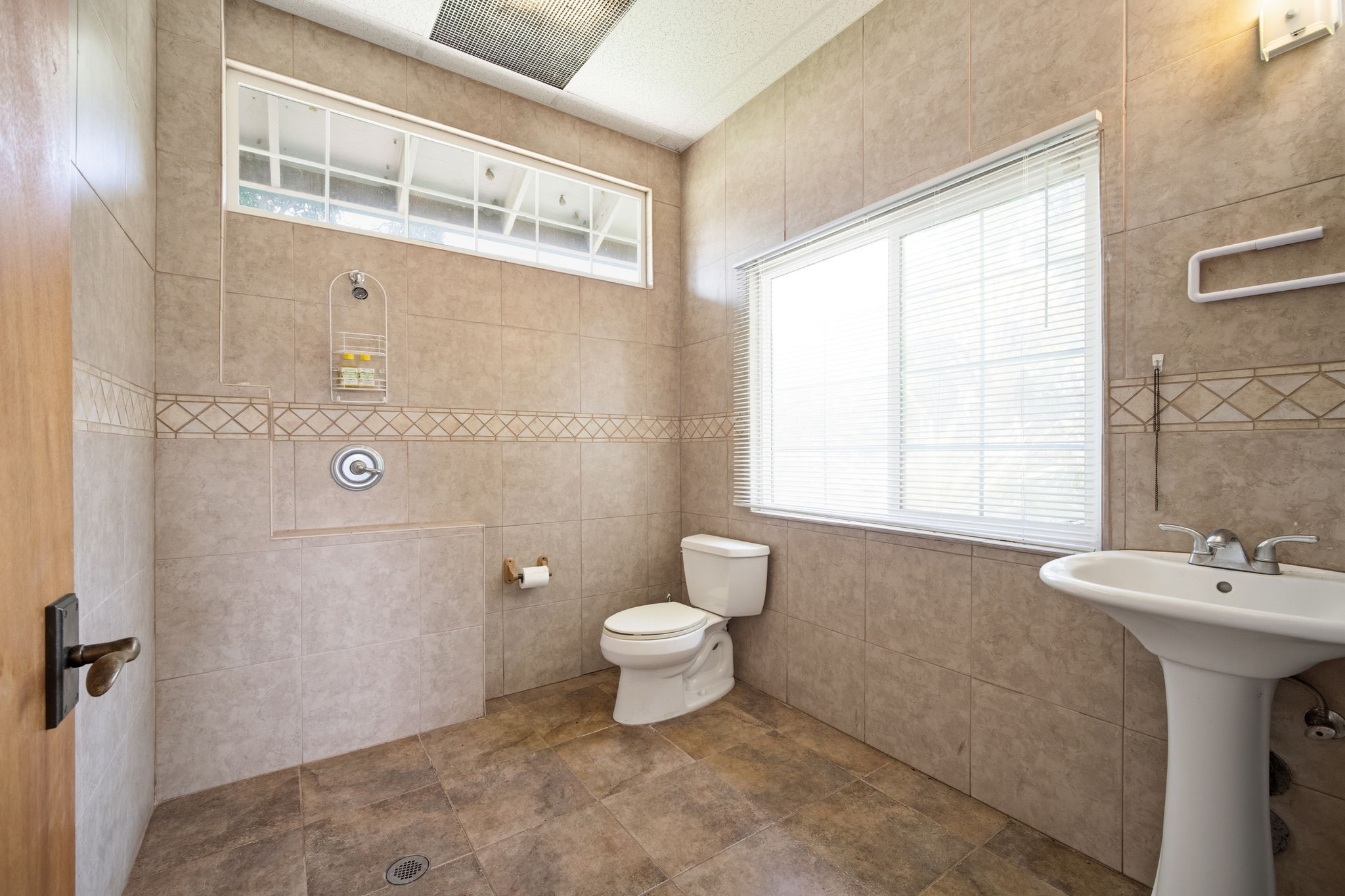 8297 Kekaha Road Kekaha, HI 96752 - Photo 14 of 27 a bathroom with a sink a toilet and shower