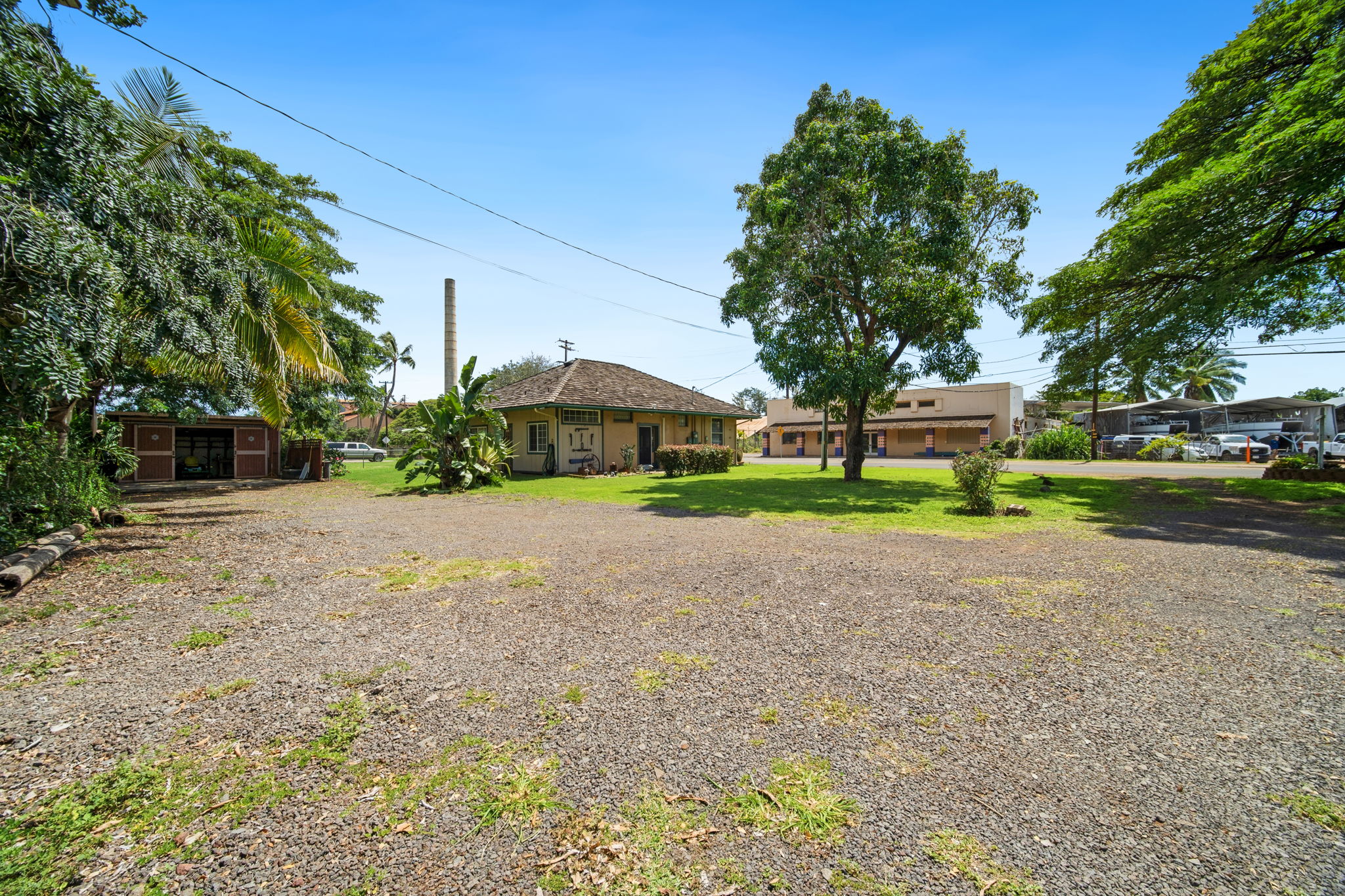 8297 Kekaha Road Kekaha, HI 96752 - Photo 2 of 27 a house with trees in front of it
