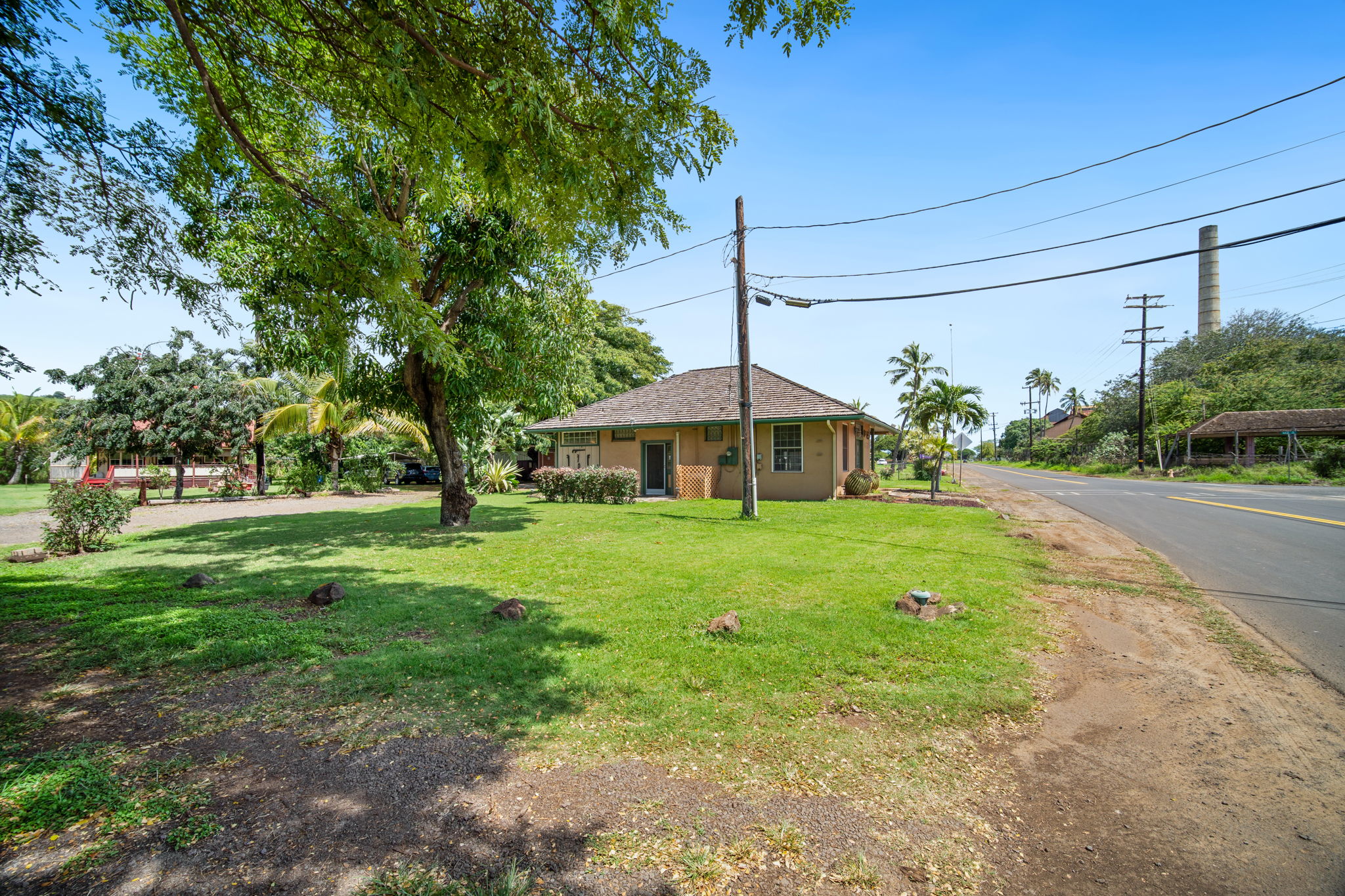 8297 Kekaha Road Kekaha, HI 96752 - Photo 3 of 27 a front view of a house with yard and tree