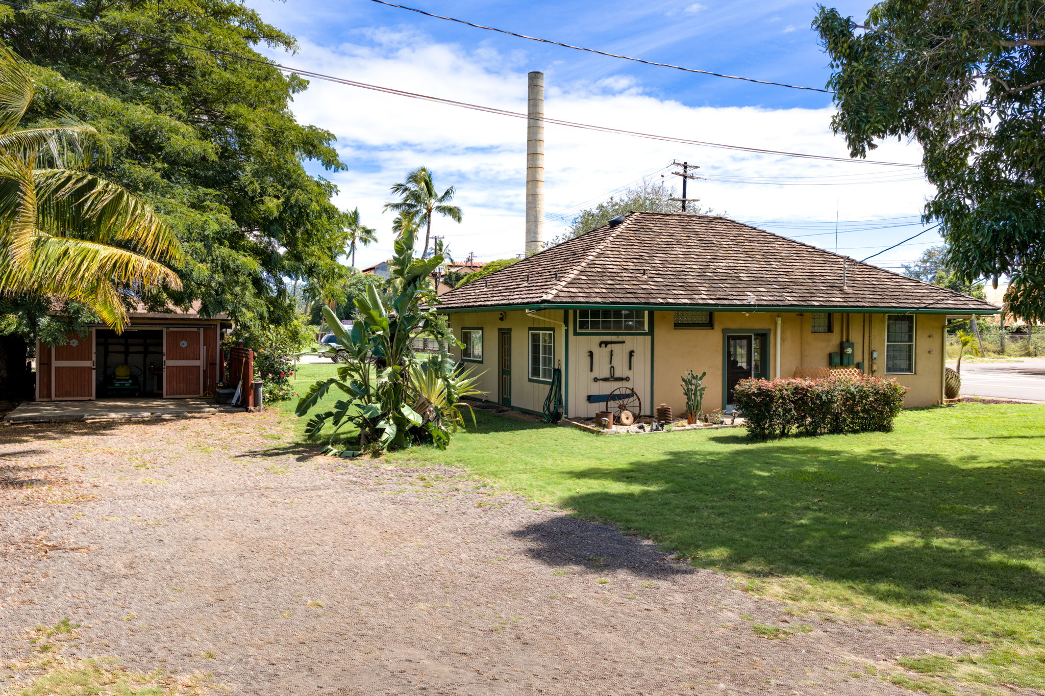 8297 Kekaha Road Kekaha, HI 96752 - Photo 6 of 27 a front view of a house with a garden