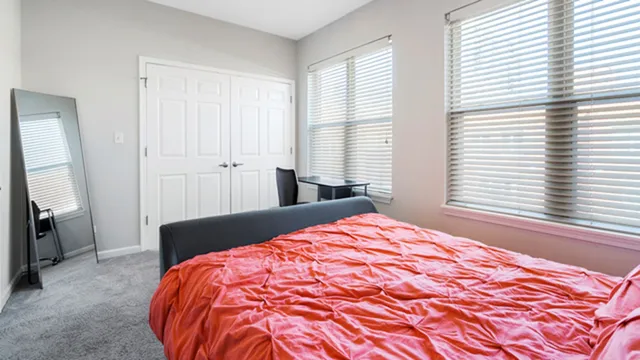 a bedroom with a bed and a window