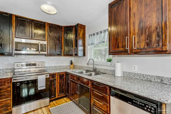 a kitchen with stainless steel appliances a stove sink and cabinets