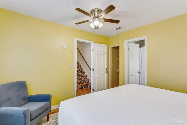 a bedroom with a bed and a couch