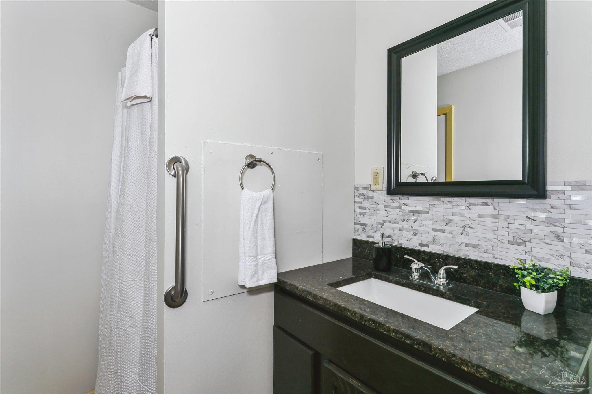 6 Ruffin Circle Pensacola, FL 32503 - Photo 16 of 42 a bathroom with a granite countertop sink and a mirror