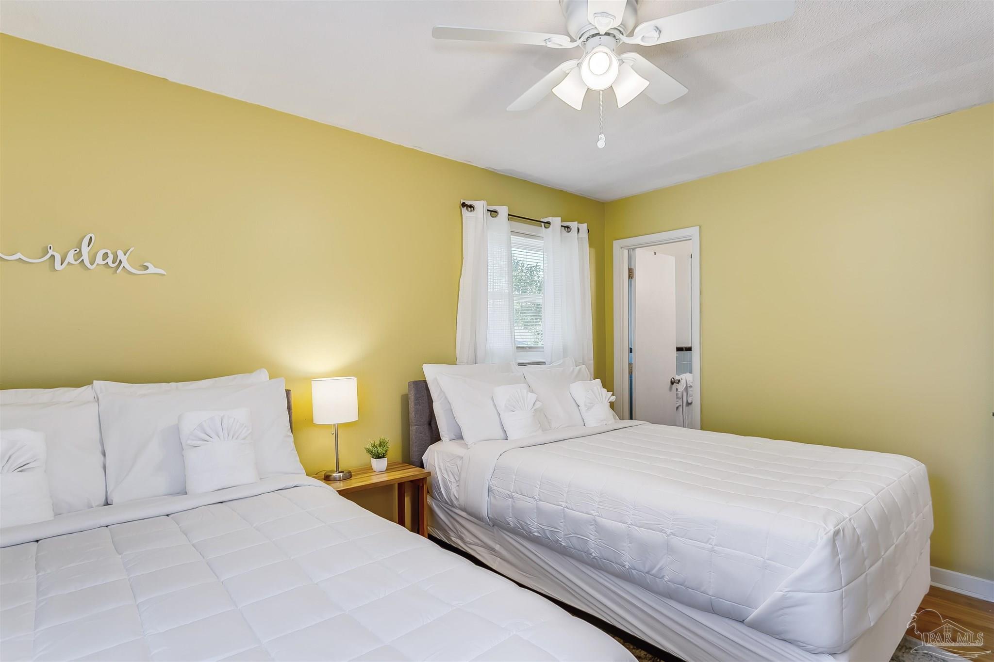 6 Ruffin Circle Pensacola, FL 32503 - Photo 18 of 42 a bedroom with a bed and a chandelier