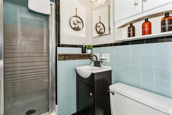 a bathroom with a toilet a sink and a shower