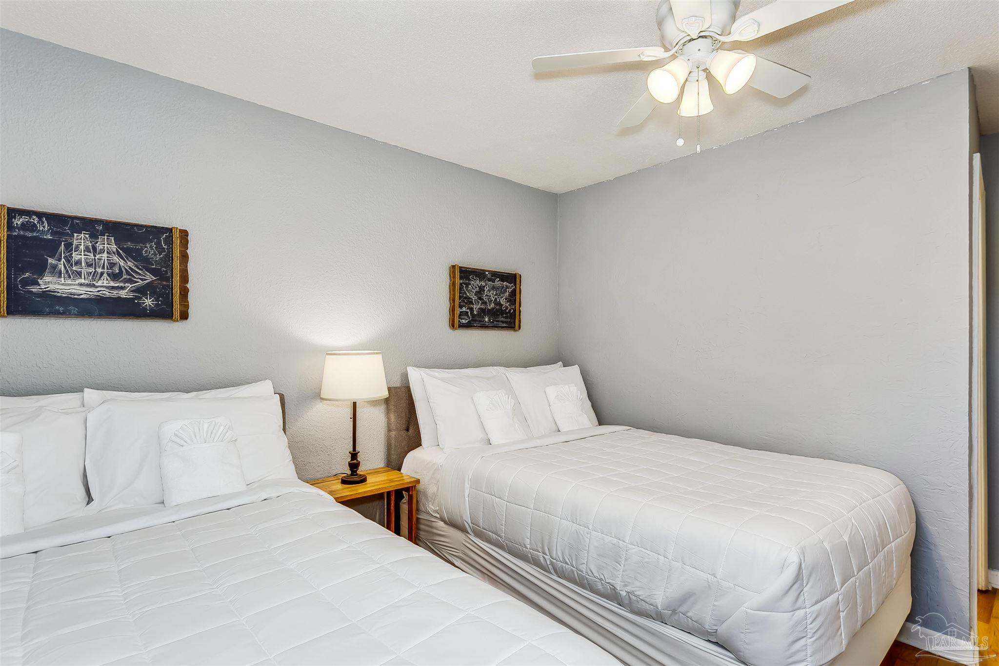 6 Ruffin Circle Pensacola, FL 32503 - Photo 21 of 42 a bedroom with a large bed and a chandelier